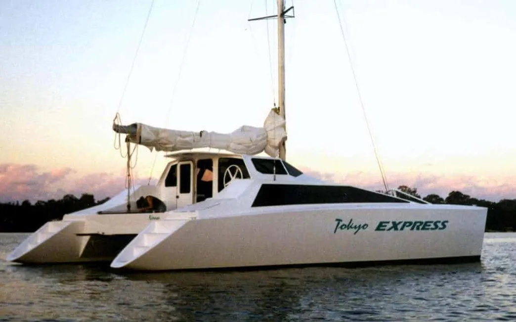 Tokyo Express catamaran at anchor — hull visible on calm water